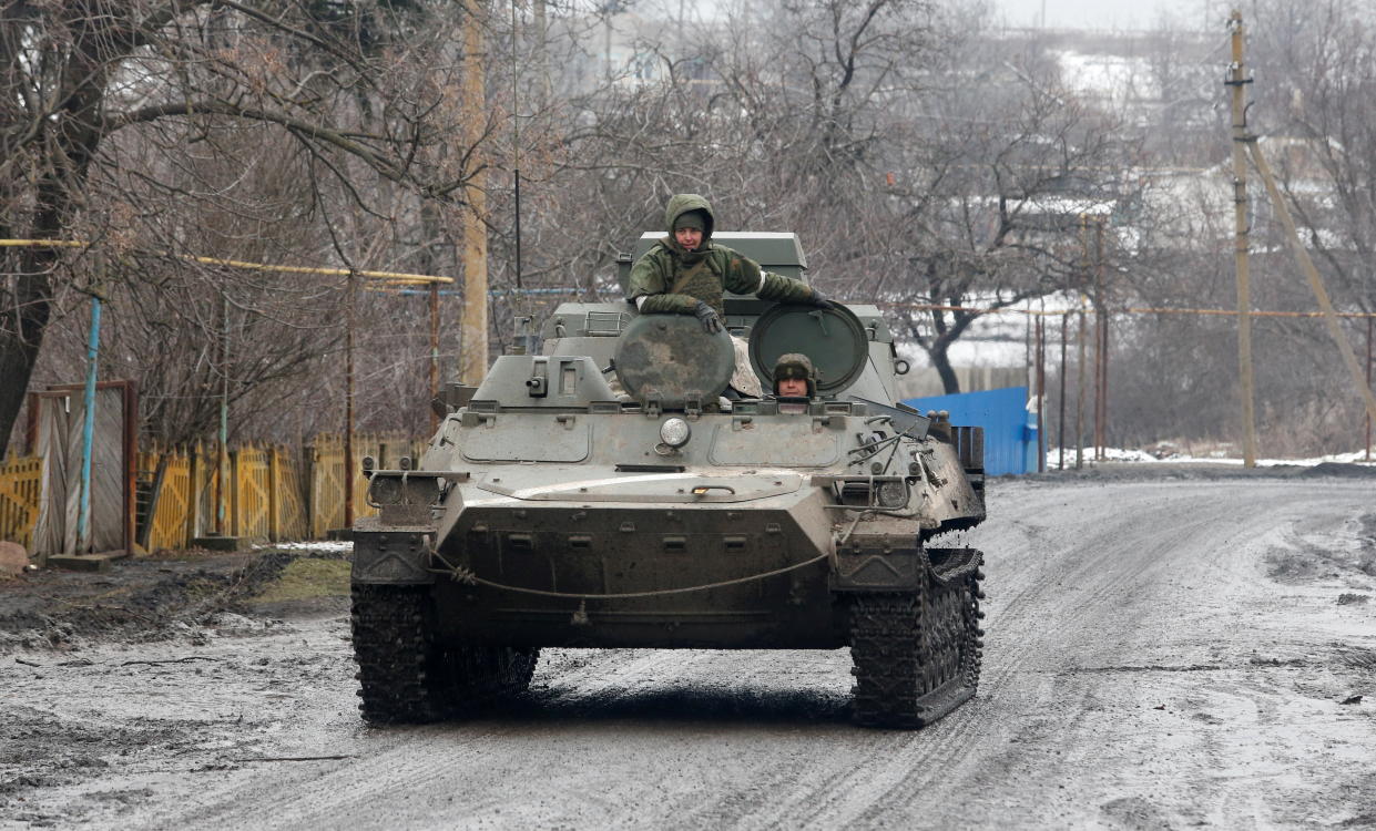 Service members of pro-Russian troops in uniforms without insignia drive an armoured vehicle in the separatist-controlled settlement of Rybinskoye during Ukraine-Russia conflict in the Donetsk region, Ukraine March 5, 2022. REUTERS/Alexander Ermochenko