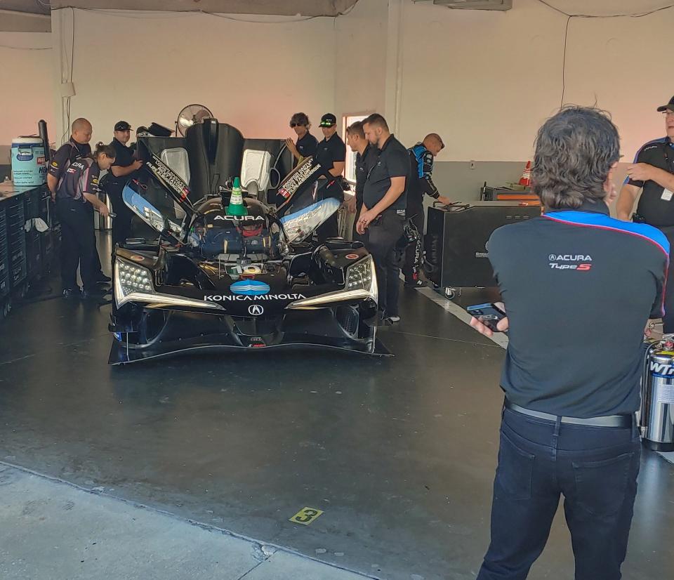 Team owner Wayne Taylor watches his team prep their brand new Acura prototype.