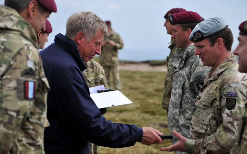 General Sir Cedric Delves awards then-Major Dom Nicholls his Operational Service Medal for service in Afghanistan, on top of Pen-Y-Fan, Brecon Beacons, Wales. Photo taken June 2011. - Rupert Frere RLC/Crown Copyright