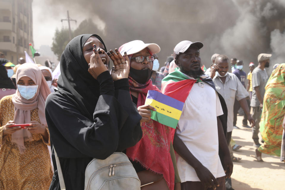 Sudanese demonstrators take to the streets of the capital Khartoum to demand the government's transition to civilian rule in Khartoum, Sudan, Thursday, Oct. 21, 2021. The relationship between military generals and Sudanese pro-democracy groups has deteriorated in recent weeks over the country's future. (AP Photo/Marwan Ali)