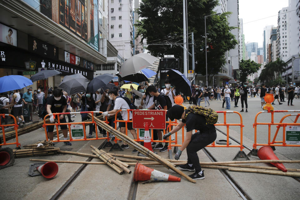 Protesters set up blockades during a protest against Beijing's national security legislation in Hong Kong, Sunday, May 24, 2020. Hundreds of protesters took to the streets Sunday to march against China’s proposed tough national security legislation for the city. (AP Photo/Kin Cheung)