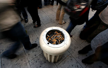 School students stand around an ashtray on the pavement outside their school in Nice, France, January 30, 2007. REUTERS/Eric Gaillard/File Photo
