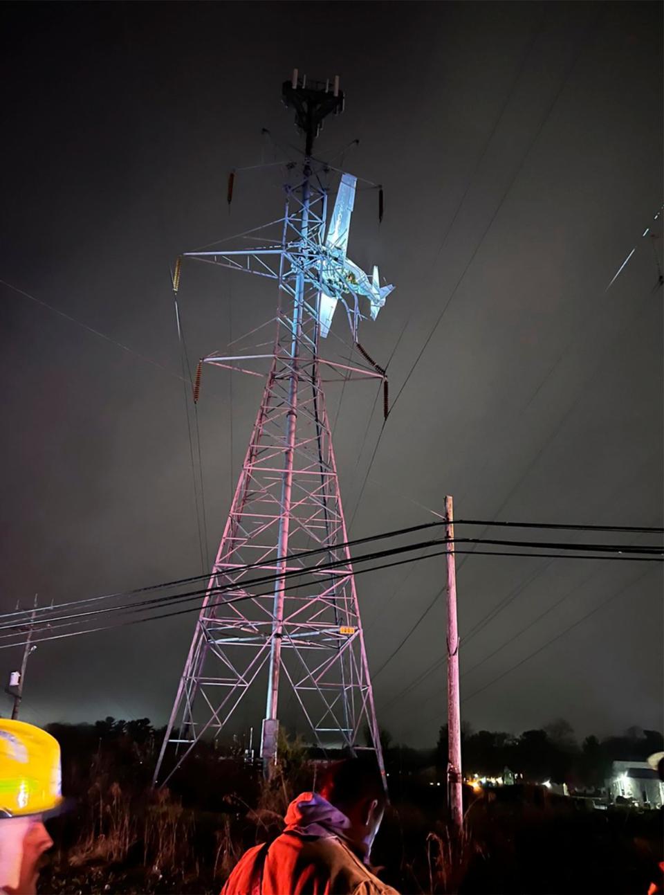 In this photo provided by Montgomery County Fire and Rescue, a small plane rests on live power lines after crashing, Sunday, November 27, 2022.