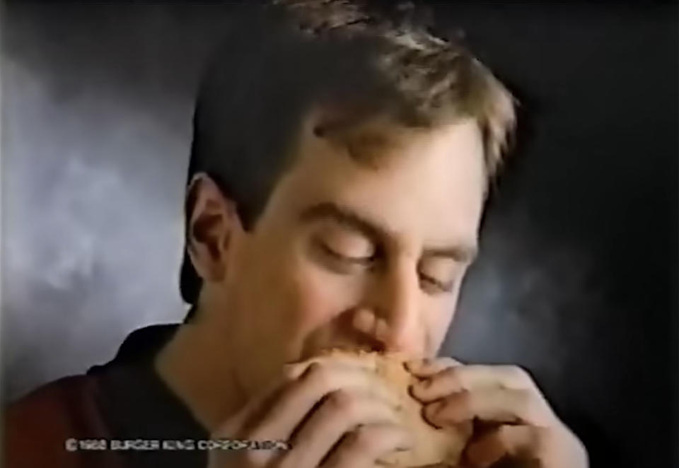 A young Christoper Meloni bites into his Yumbo sandwich in a commercial for Burger King. (Late Night with Seth Meyers / YouTube)