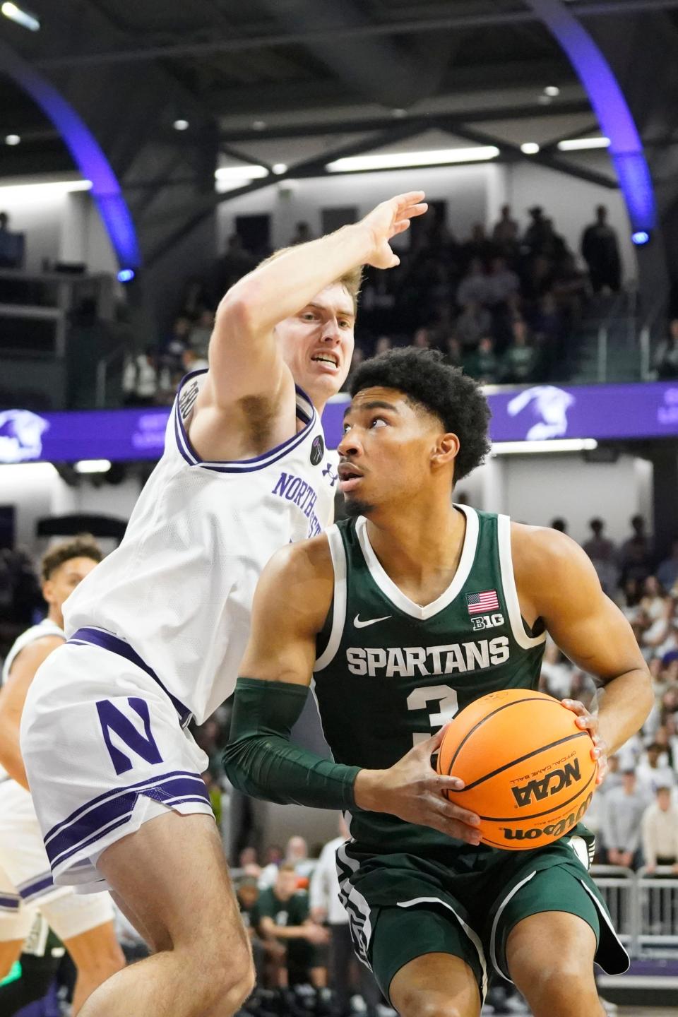 Northwestern Wildcats guard Brooks Barnhizer (13) defends Michigan State Spartans forward Malik Hall (25) during the first half at Welsh-Ryan Arena in Evanston, Illinois, on Sunday, Jan. 7, 2024.
