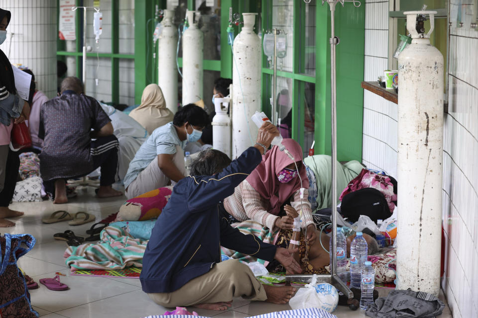 Oxygen tanks are prepared for patients in the hallway of an overcrowded hospital amid a surge of COVID-19 cases, in Surabaya, East Java, Indonesia, Friday, July 9, 2021. The world's fourth most populous country is running out of oxygen as it endures a devastating wave of coronavirus cases and the government is seeking emergency supplies from other countries, including Singapore and China. (AP Photo/Trisnadi)