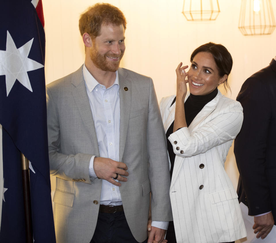 Britain's Prince Harry and his wife Meghan, Duchess of Sussex, attend a lunchtime reception hosted by Australian Prime Minister Scott Morrison with Invictus Games competitors, their families and friends in Sydney Sunday, Oct. 21, 2018. (Paul Edwards/Pool Photo via AP)