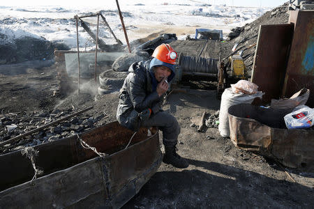 A miner smokes a cigarette at a primitive coal mine outside Ulaanbaatar, Mongolia January 27, 2017. The miners at the Nalaikh coal deposit, outside the Mongolian capital, go as much as 60 meters underground to mine the coal. REUTERS/B. Rentsendorj