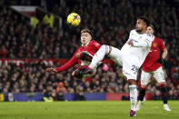 Leeds United's Weston McKennie, right, and Manchester United's Lisandro Martinez battle for the ball during an English Premier League soccer match at Old Trafford in Manchester, England, Wednesday, Feb. 8, 2023. (Martin Rickett/PA via AP)