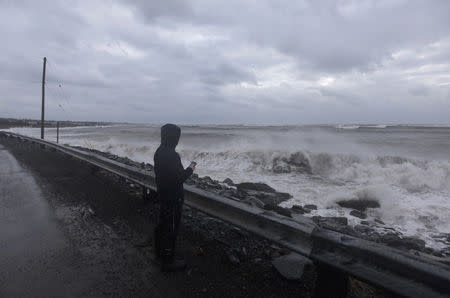 A man films storm surge from the Atlantic Ocean during Storm Grayson in Halifax, Nova Scotia, Canada January 5, 2018. REUTERS/Darren Calabrese