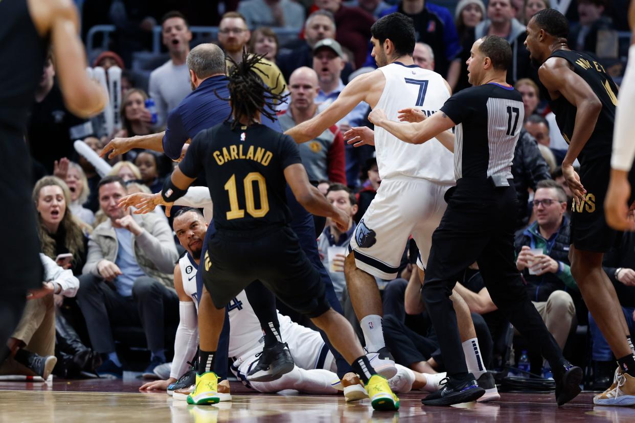 Memphis Grizzlies forward Dillon Brooks lays on the ground during a second-half fight with Cavaliers guard Donovan Mitchell, Thursday, Feb. 2, 2023, in Cleveland. Mitchell and Brooks were ejected from the game.