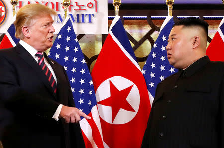 U.S. President Donald Trump speaks to North Korean leader Kim Jong Un after shaking hands before their one-on-one chat during the second U.S.-North Korea summit at the Metropole Hotel in Hanoi, Vietnam February 27, 2019. REUTERS/Leah Millis/Files