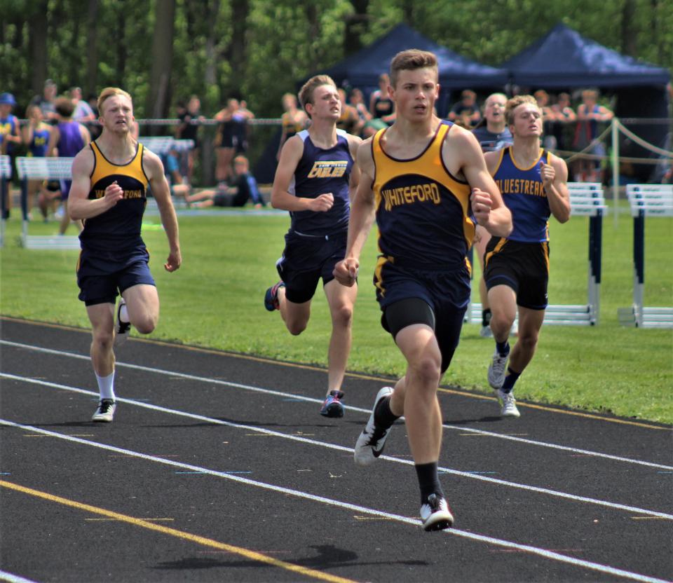 Jacob Iott of Whiteford runs ahead of the pack to take first place in the 400 during the Division 3 Regional Saturday, May 21, 2022 at Whiteford. Behind are Whiteford's Ty Ruddy (from left), Mason's Jackson Iocoangeli, and Ida's Wyatt Dirkmaat.