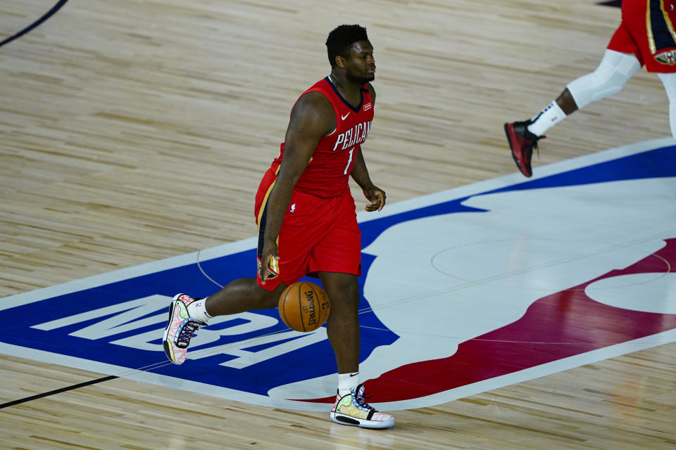 New Orleans Pelicans' Zion Williamson (1) brings the ball up court against the Memphis Grizzlies during the second half of an NBA basketball game Monday, Aug. 3, 2020 in Lake Buena Vista, Fla. (AP Photo/Ashley Landis, Pool)