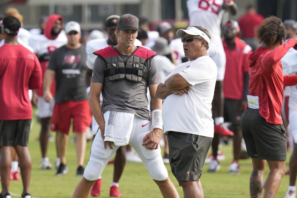 Tampa Bay Buccaneers quarterback Tom Brady (12) with coach Clyde Christensen during an NFL football training camp practice Wednesday, Aug. 10, 2022, in Tampa, Fla. (AP Photo/Chris O'Meara)