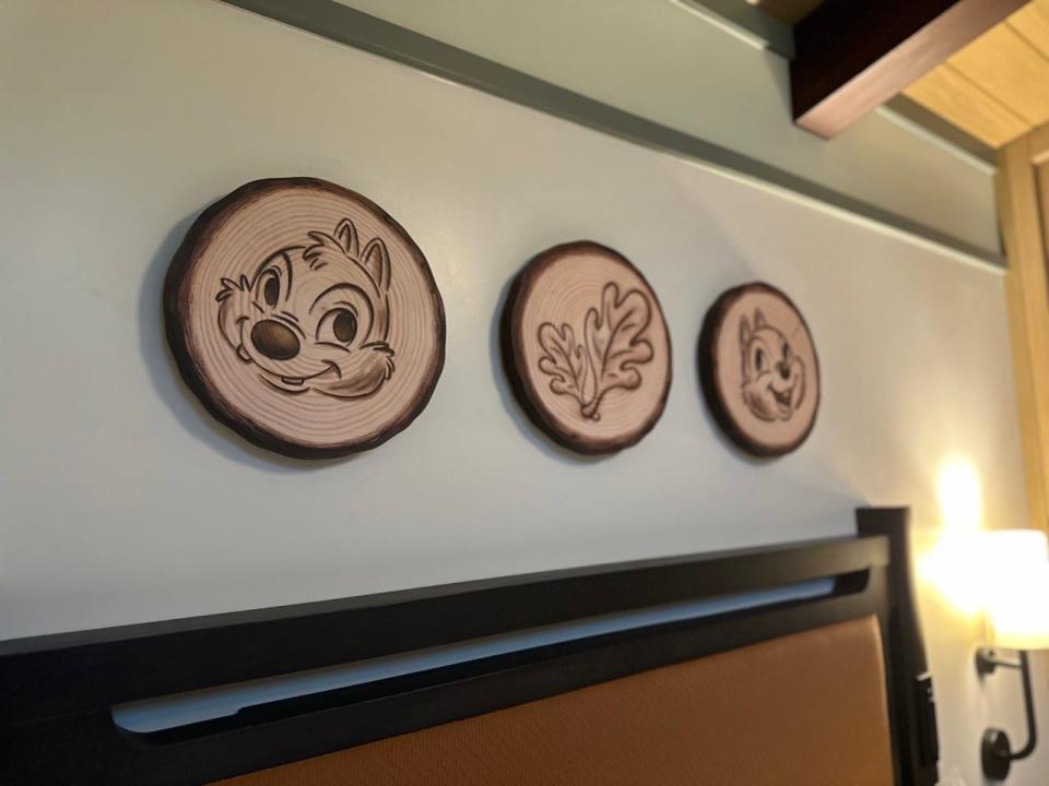 Chip and Dale etched onto wood on wall 