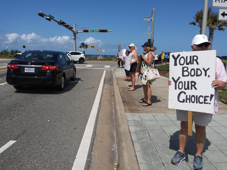 Demonstrators gather near Veterans Park in Flagler Beach Saturday, June 25, to protest the Supreme Court's ruling to overturn Roe v. Wade.