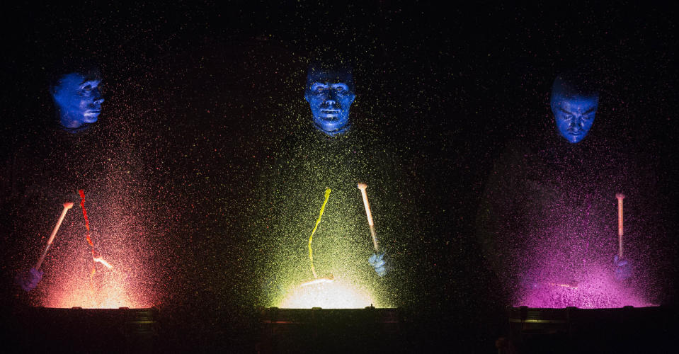 In this July 10, 2013, photograph, members of the Blue Man Group perform at the Briar Street Theatre. Blue Man Group, which started with three friends in New York more than two decades ago, has grown from an off-Broadway show to also have productions in Boston, Chicago, Las Vegas and Orlando, Fla. A tour will soon take the blue men to stops in cities like Atlantic City, N.J.; Durham, N.C.; Lincoln, Neb.; Corpus Christi, Texas; Portland, Maine; and Kennewick, Wash. (AP Photo/Scott Eisen)