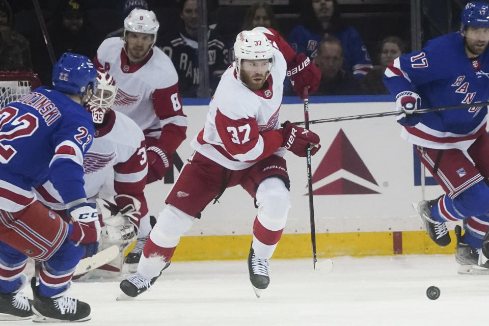 Detroit Red Wings' J.T. Compher (37) goes to clear the puck during the first period of an NHL hockey game against the New York Rangers, Wednesday, Nov. 29, 2023, in New York. (AP Photo/Bebeto Matthews)