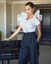 <p>rocks the ruffle trend in a statement white top and navy tapered trousers by Prabal Gurung, plus dazzling Tiffany and Co. earrings. </p>