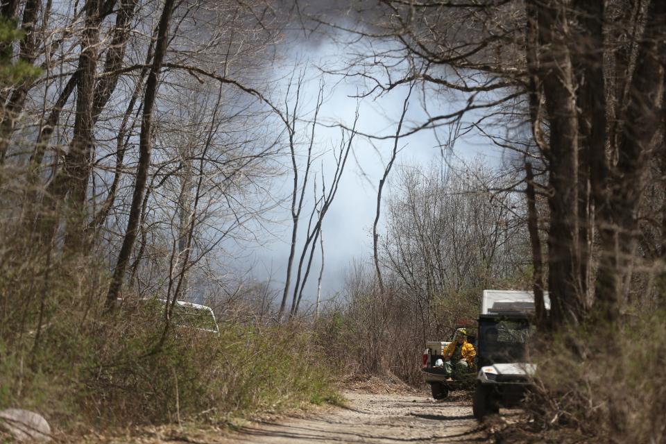 An access road where first responders including the NJ Forest Fire Service and local teams battle a forest fire in the mountains of West Milford, NJ on April 13, 2023.