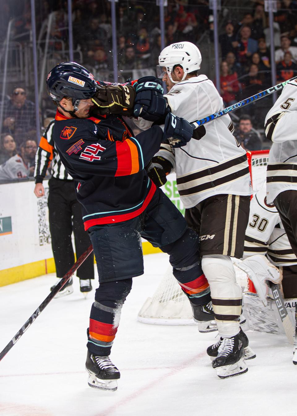 Jimmy Schuldt (#44) receives a punch from an opponent during a heated moment in the AHL Calder Cup Finals game between the Coachella Valley Firebirds and the Hershey Bears at Acrisure Arena in Palm Desert, CA on June 8, 2023