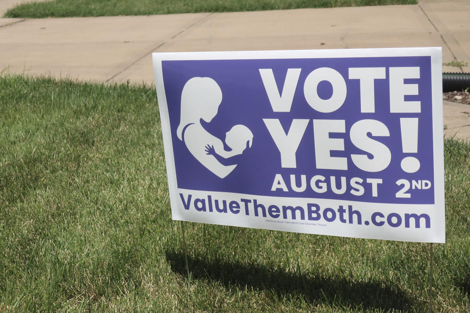 FILE - In this photo from Friday, July 8, 2022, a sign in a yard in Olathe, Kansas, promotes a proposed amendment to the Kansas Constitution to allow legislators to further restrict or ban abortion. Supporters call the measure "Value Them Both," arguing that it protects both unborn children and the women carrying them. (AP Photo/John Hanna, File)