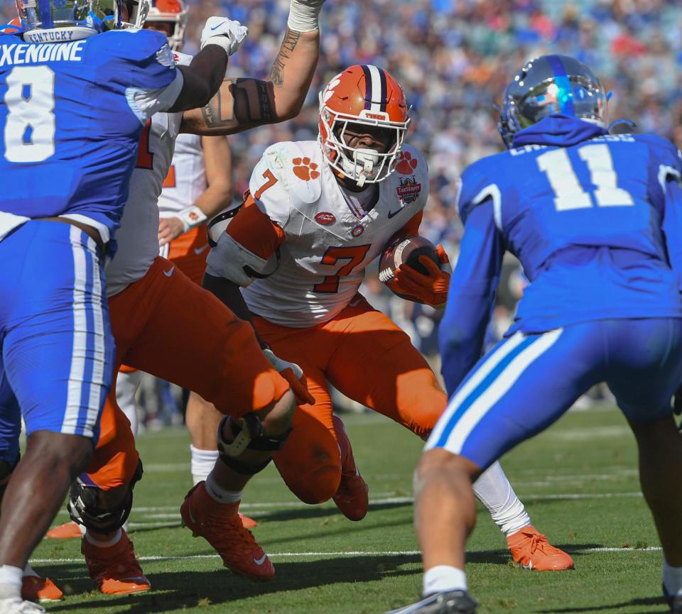 Clemson running back Phil Mafah (7) scores near Kentucky defensive back Zion Childress (11) during the second quarter of the TaxSlayer Gator Bowl at EverBank Stadium in Jacksonville, Florida, Friday, December 29, 2023.