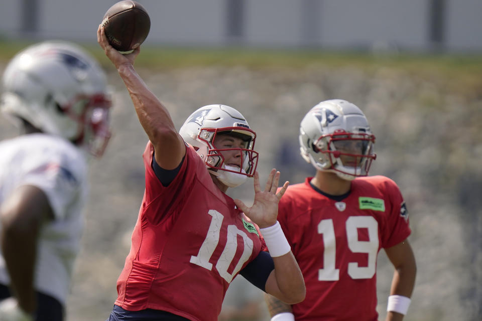 New England Patriots quarterback Mac Jones (10) throws a pass in front of quarterback Matt Corral (19) during NFL football practice, Wednesday, Sept. 6, 2023, in Foxborough, Mass. (AP Photo/Steven Senne)