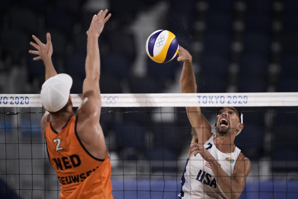 Robert Meeuwsen, of the Netherlands, blocks against Nicholas Lucena, of the United States, during a men's beach volleyball match at the 2020 Summer Olympics, Saturday, July 24, 2021, in Tokyo, Japan. (AP Photo/Felipe Dana)