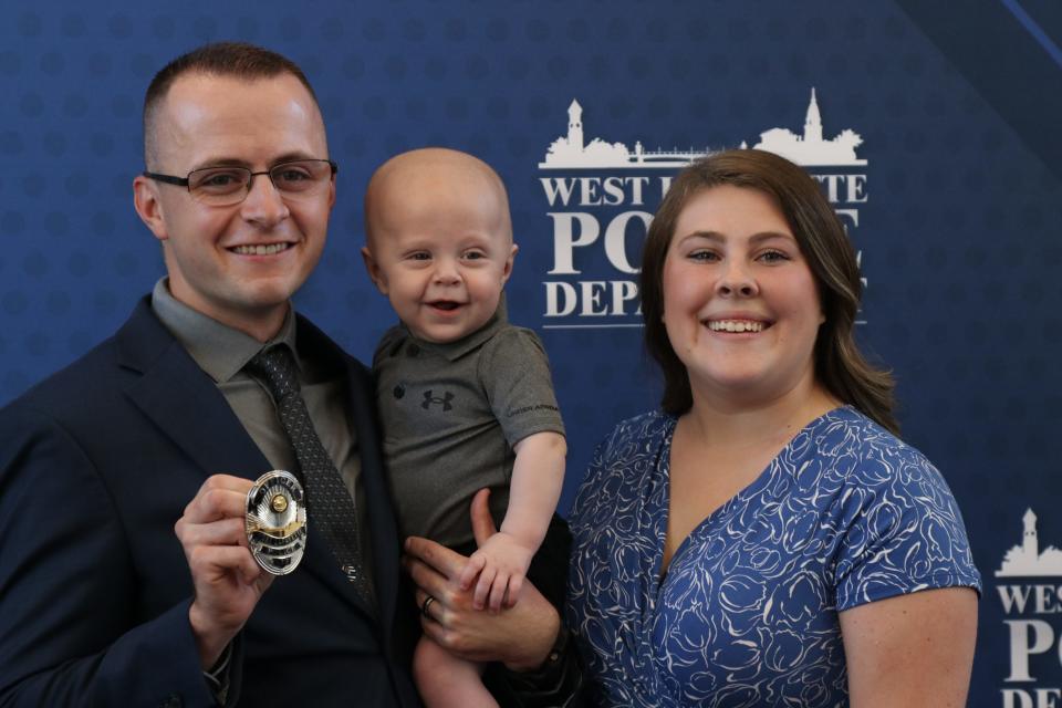 West Lafayette Police Department's newest Officer Jacob Forgey poses for a photo with his family after his swearing-in ceremony, on June 28, 2022, at the West Lafayette City Hall.