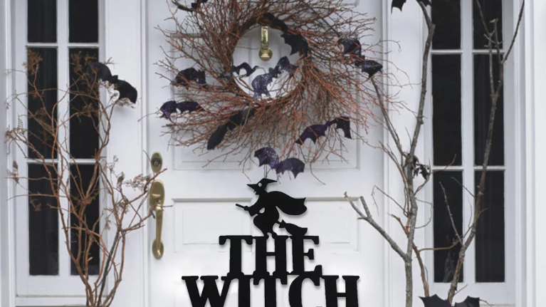 door sign that says the witch is in