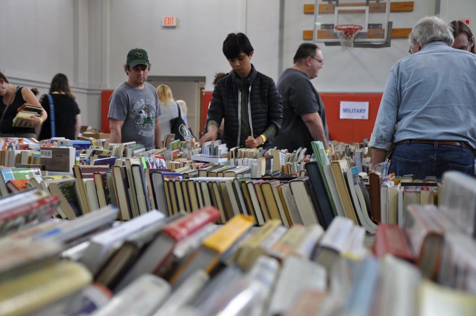 Joseph Seefeldt, 13, of Damascus, browses a line of books at the 2023 Friends of Rodman Public Library Used Book Sale on Saturday, Aug. 5, 2023, at the Alliance Commons.
