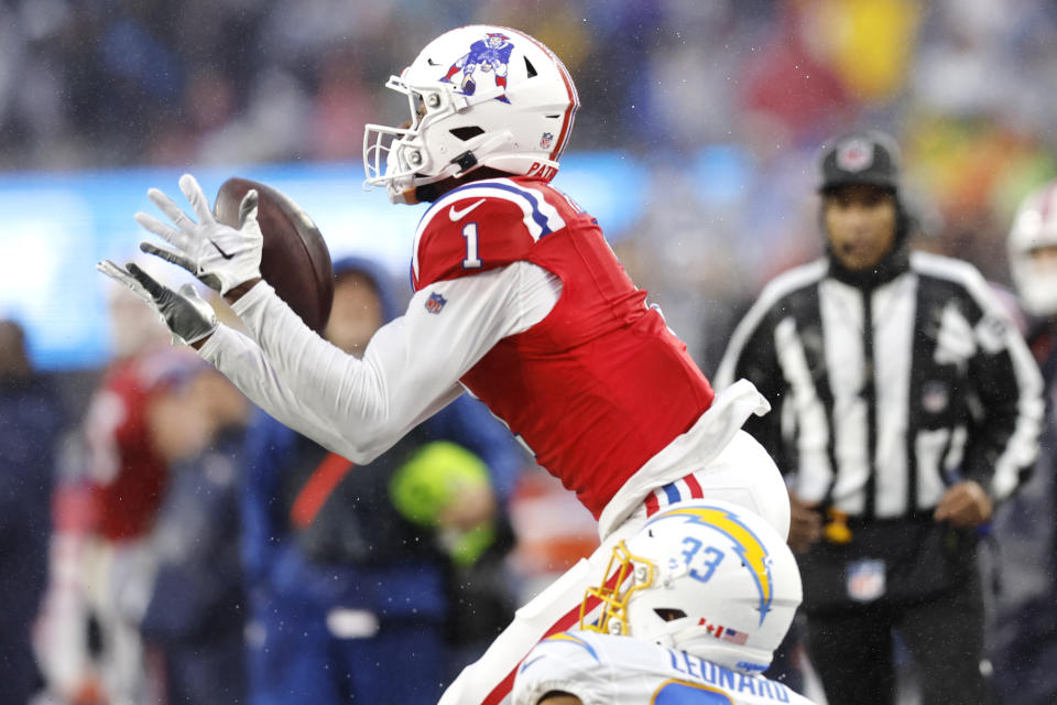 New England Patriots wide receiver DeVante Parker (1) hauls in a pass against Los Angeles Chargers cornerback Deane Leonard (33) during the second half of an NFL football game, Sunday, Dec. 3, 2023, in Foxborough, Mass. (AP Photo/Michael Dwyer)