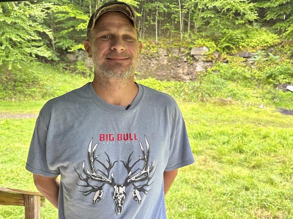 Eric McCarthy, an elk guide, poses for a photo at a hunting camp in Penfield, Pa., Aug. 23, 2023. McCarthy says he and a client heard loud clanking noises and saw a loaded armored truck during a 2018 FBI operation to recover a legendary cache of Civil War-era gold, which the FBI insists came up empty. (AP Photo/Michael Rubinkam)
