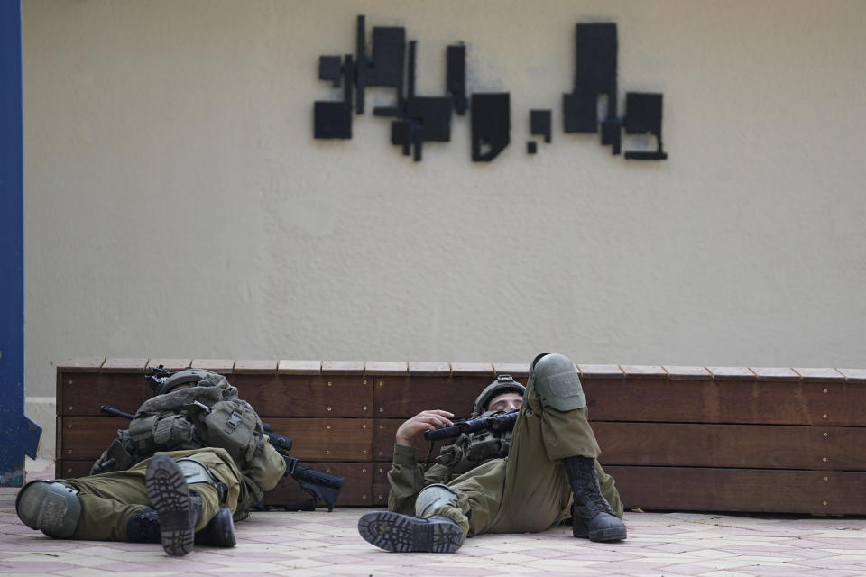 FILE - Israeli soldiers sleep near a police station that was overrun by Hamas militants on Saturday, in Sderot, Israel, Sunday, Oct.8, 2023. Hamas militants stormed over the border fence Saturday, killing hundreds of Israelis in surrounding communities. (AP Photo/Ohad Zwigenberg, File)