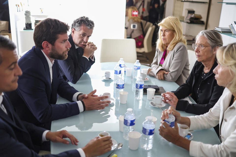 French Prime Minister Elisabeth Borne second right, Interior Minister Gerald Darmanin, left, , Secretary of State for Rurality Dominique Faure, third right, and Minister for Ecological Transition and Territories' Cohesion Christophe Bechu third left, meet with Vincent Jeanbrun second left, the Mayor of L'Hay-les-Roses, after rioters rammed a vehicle into his house overnight, at the City Hall in L'Hay-les-Roses, south of Paris, Sunday, July 2, 2023. Young rioters clashed with police and targeted the mayor's home with a burning car as France saw a fifth night of unrest sparked by the police killing of a teenager. (Charly Triballeau/Pool Photo via AP)