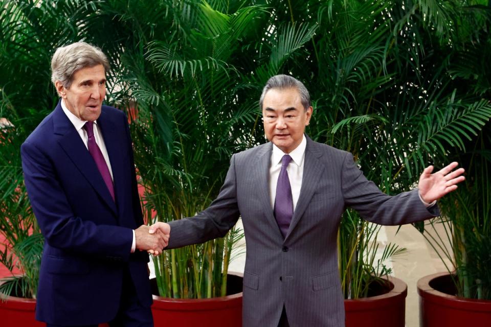 US climate envoy John Kerry (L) is greeted by top Chinese diplomat Wang Yi (Getty Images)