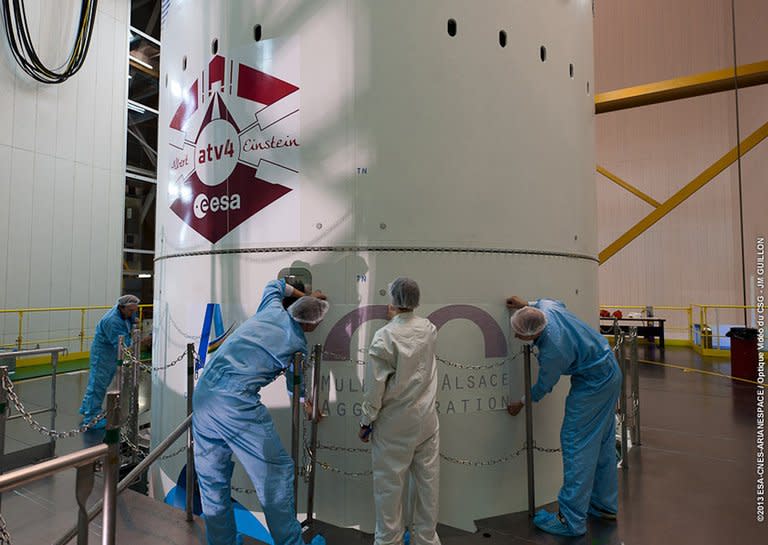 Logos are applied to the Ariane 5’s payload at Kourou space center, French Guiana, May 28, 2013. The payload is the fourth cargo delivery by the European Space Agency (ESA) to the International Space Station (ISS), bringing food, water, oxygen, scientific experiments and special treats to the orbiting crew