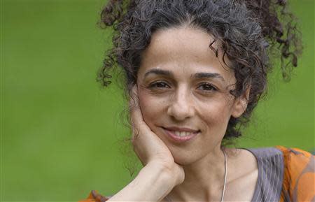 Masih Alinejad, 37, a Britain-based Iranian journalist, poses for a portrait in London October 8, 2013. Alinejad, a former reporter in Iran, left the country a week before the 2009 elections to study abroad and stayed outside after the unrest and crackdown on reformist press. REUTERS/Toby Melville