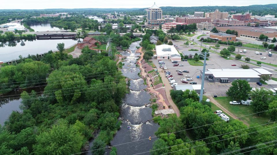 Water and paddlers flow through Wausau Whitewater Park during a recreational release on August 7, 2022.