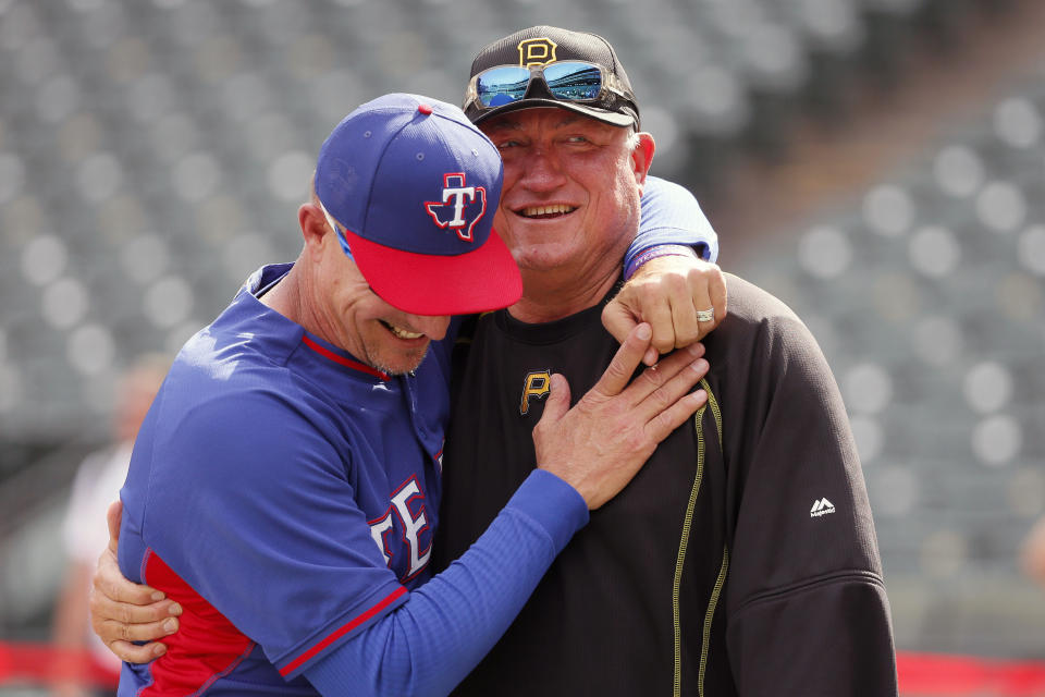 FILE - In this May 27, 2016, file photo, Texas Rangers manager Jeff Banister, left, and Pittsburgh Pirates manager Clint Hurdle greet each other during batting practice before a baseball game in Arlington, Texas. Hurdle began sending his daily notes of inspiration more than 10 years ago, during his days managing the Colorado Rockies. They were a simple, small way of checking in with everybody on his staff to discuss leadership ideas or offer support. (AP Photo/Tony Gutierrez, File)