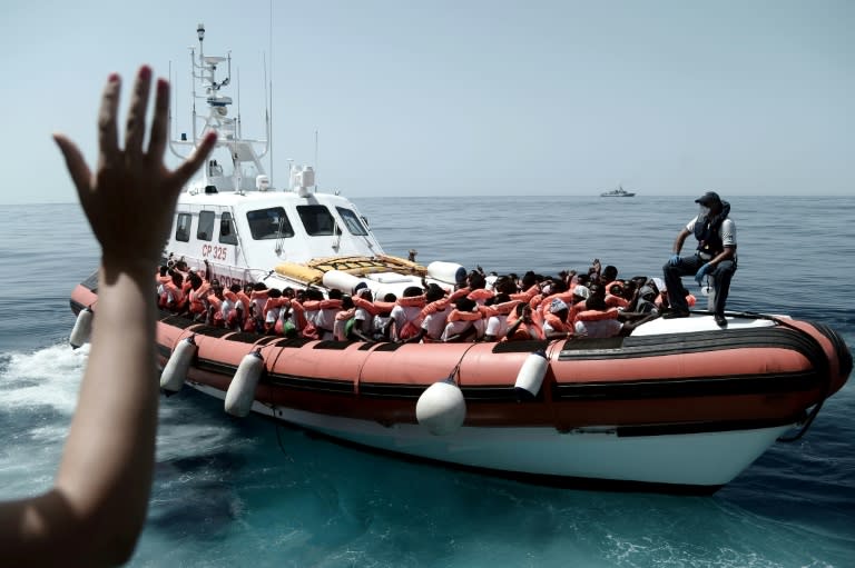 This handout picture from Medecins Sans Frontiers shows rescued migrants onboard an Italian coastguard ship following their transfer from the French NGO's ship Aquarius