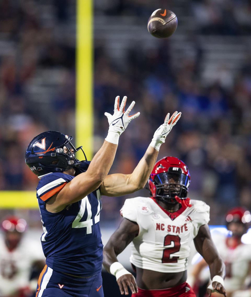 Virginia tight end Sackett Wood Jr. (44) waits for the ball on a pass reception against North Carolina State linebacker Jaylon Scott (2) during the first half of an NCAA college football game Friday, Sept. 22, 2023, in Charlottesville, Va. (AP Photo/Mike Caudill)