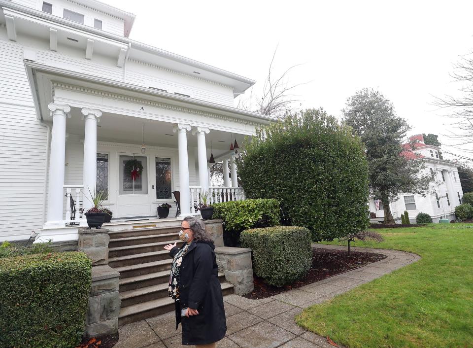 Cultural Resource Manager and Architectural Historian Michelle Sadlier stands in front of Quarters A on Officers Row at Naval Base-Kitsap Bremerton on Dec. 18.