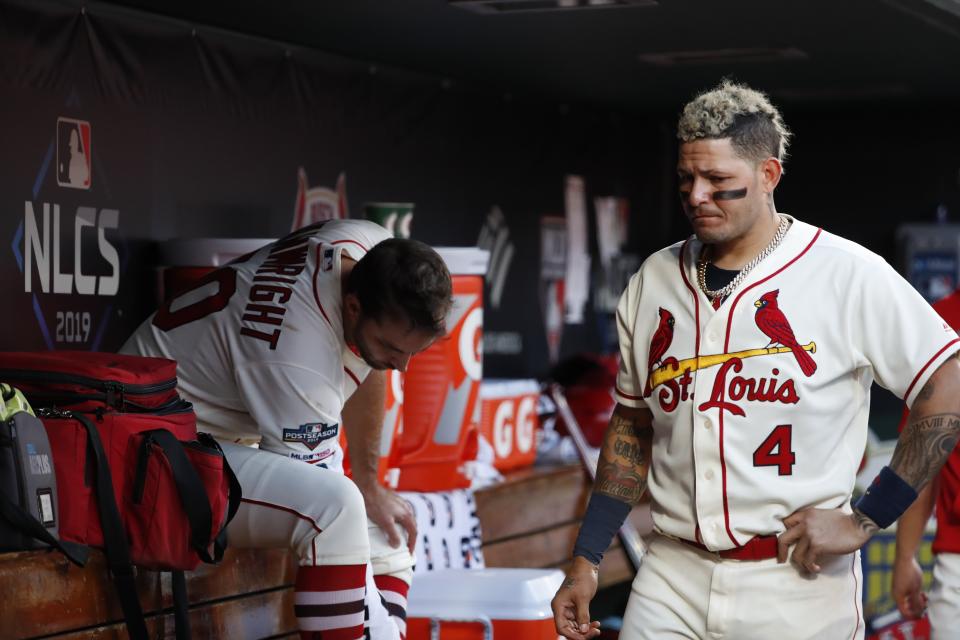 St. Louis Cardinals' Yadier Molina (4) and Adam Wainwright are seen in the dugout during the seventh inning of Game 2 of the baseball National League Championship Series against the Washington Nationals Saturday, Oct. 12, 2019, in St. Louis. (AP Photo/Jeff Roberson)