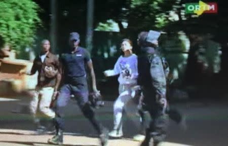 Still image from video show a hostage rushed out from the Radisson hotel in Bamako, Mali, November 20, 2015. REUTERS/REUTERS TV