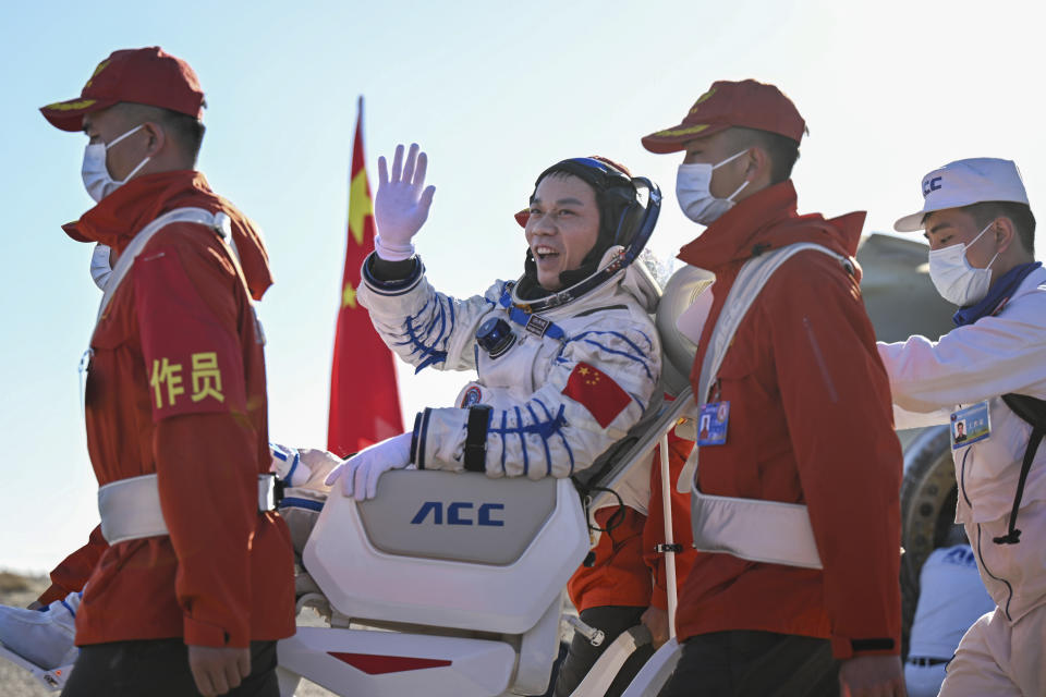 In this photo released by Xinhua News Agency, Tang Hongbo, a Chinese astronaut and a commander waves as he is carried out of the re-entry capsule of the Shenzhou-17 manned space mission after it landed successfully at the Dongfeng landing site in northern China's Inner Mongolia Autonomous Region, Tuesday, April 30, 2024. China's Shenzhou-17 spacecraft returned to Earth Tuesday, carrying three astronauts who have completed a six-month mission aboard the country's orbiting space station. (Lian Zhen/Xinhua via AP)