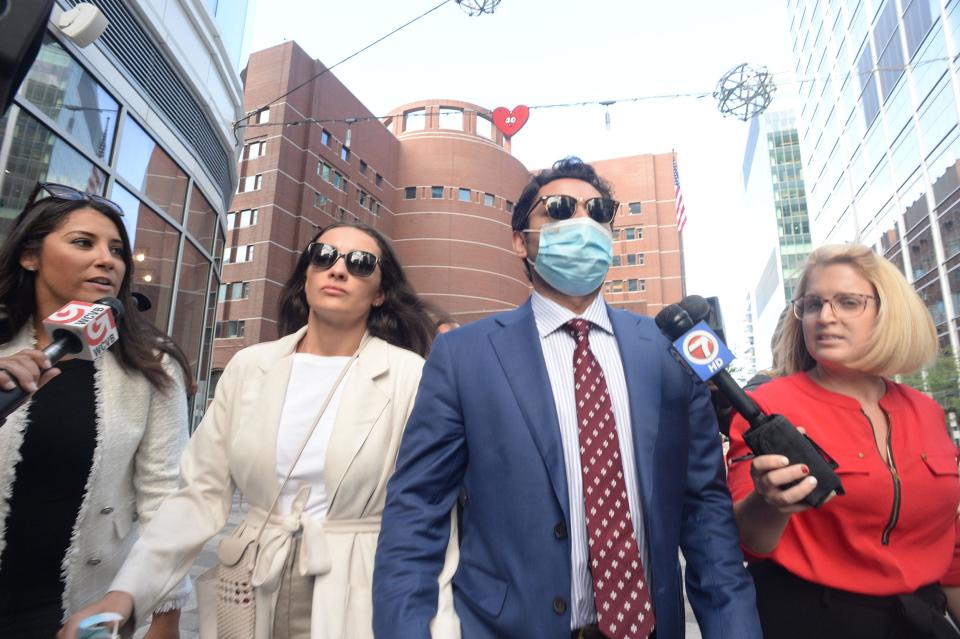 Former Fall River Mayor Jasiel Correia II leaves the John Joseph Moakley Federal Courthouse in Boston on Tuesday with his wife,  Jen Fernandes.