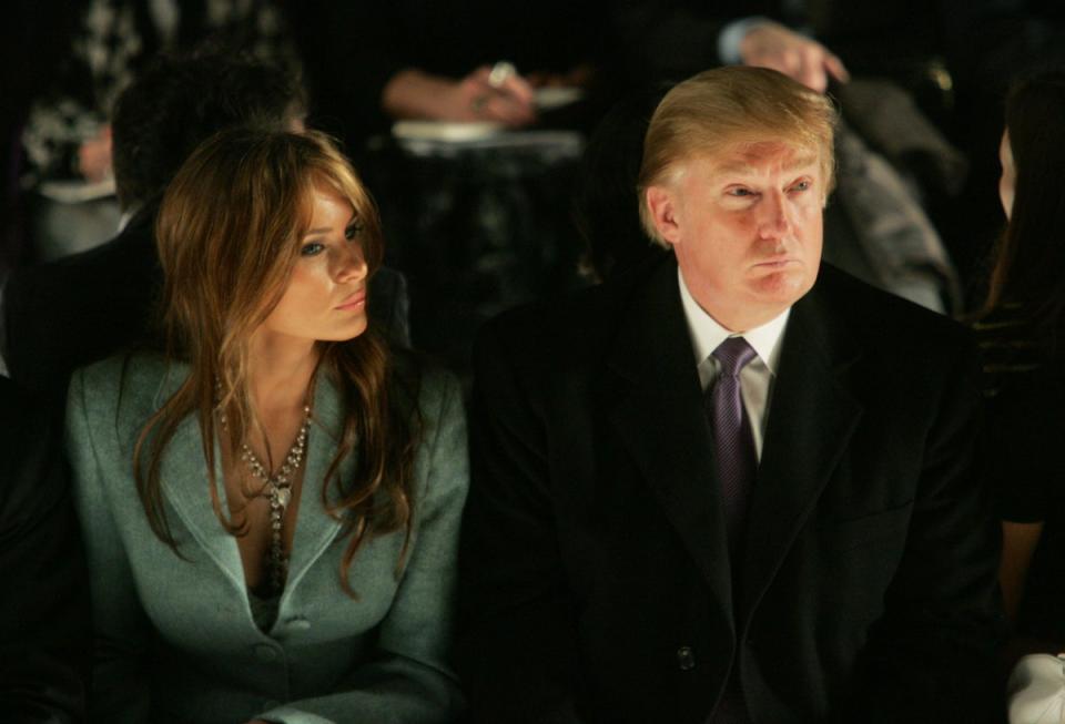 Donald and Melania Trump attend the Michael Kors show during Olympus Fashion Week at Bryant Park in New York on 9  February 2005 (Getty)